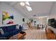 Bright living room with modern decor, vaulted ceilings, fan, and wood flooring at 6626 N Majorca E Way, Phoenix, AZ 85016