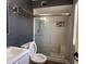 Modern bathroom featuring a sleek glass shower, updated fixtures, and contemporary vanity for a spa-like experience at 6823 W Garfield St, Phoenix, AZ 85043