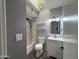 Cozy bathroom featuring a shower/tub combo, updated fixtures, and a modern vanity for a contemporary feel at 6823 W Garfield St, Phoenix, AZ 85043