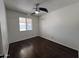 Bedroom featuring wood-look floors, ceiling fan, and window at 6823 W Garfield St, Phoenix, AZ 85043