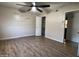 Bedroom featuring light-colored walls, ceiling fan, and wood-look flooring at 6823 W Garfield St, Phoenix, AZ 85043