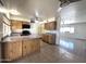 Kitchen featuring wood cabinets, stainless steel appliances, and an island, open to a connecting living room at 6823 W Garfield St, Phoenix, AZ 85043