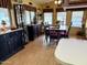 Well-lit dining area showcasing cabinetry, wood floors, and space for six around the table at 7750 E Broadway Rd # 123, Mesa, AZ 85208