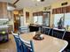 A dining room with a wood table, blue chairs with purple cushions, and a hutch is visible at 7750 E Broadway Rd # 123, Mesa, AZ 85208