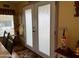 Entryway showcasing decorative glass doors, lighting, and tiled floor with dark trim at 7750 E Broadway Rd # 123, Mesa, AZ 85208