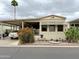Charming manufactured home with carport, xeriscaping and desert landscaping for low-maintenance living at 7750 E Broadway Rd # 123, Mesa, AZ 85208