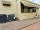 Exterior shot of manufactured home featuring HVAC system and window awning at 7750 E Broadway Rd # 123, Mesa, AZ 85208