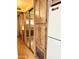 Hallway featuring a closet with mirrored doors and ample wood cabinet storage at 7750 E Broadway Rd # 123, Mesa, AZ 85208
