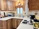 Traditional-style kitchen featuring oak cabinets, white appliances and countertops, and a double basin sink at 7750 E Broadway Rd # 123, Mesa, AZ 85208