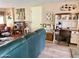 Cozy living area with a blue couch, wooden desk, and a curated bookshelf display at 7750 E Broadway Rd # 123, Mesa, AZ 85208