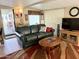 Comfortable living room featuring a green sofa, wooden coffee table, and a balcony view at 7750 E Broadway Rd # 123, Mesa, AZ 85208