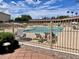 Exterior view of a community swimming pool with lounge chairs and umbrellas on a sunny day surrounded by buildings at 7750 E Broadway Rd # 123, Mesa, AZ 85208