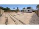 Spacious dirt backyard awaiting personalization, with a block wall and wooden edging for potential gardening at 812 E Piute Ave, Phoenix, AZ 85024