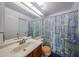 Bathroom with large mirror, vanity with sink, and a blue patterned shower curtain at 812 E Piute Ave, Phoenix, AZ 85024