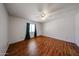 Bedroom features wood floors, bright white walls, and a ceiling fan at 812 E Piute Ave, Phoenix, AZ 85024