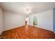 Bright bedroom features wood floors, a ceiling fan, and an en suite bathroom at 812 E Piute Ave, Phoenix, AZ 85024