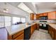 Spacious kitchen adjacent to living room features laminate countertops and stainless-steel sink at 812 E Piute Ave, Phoenix, AZ 85024