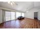 Bright living room with wood floors, ceiling fan, and sliding doors to the patio at 812 E Piute Ave, Phoenix, AZ 85024