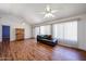 Spacious living room features wood flooring, a ceiling fan, and bright natural light at 812 E Piute Ave, Phoenix, AZ 85024