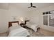 Cozy guest bedroom featuring two beds, neutral colors, and a ceiling fan at 8230 E Via Del Sol Dr, Scottsdale, AZ 85255