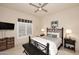 Primary bedroom with neutral tones, ceiling fan, plantation shutters, and elegant furnishings at 8230 E Via Del Sol Dr, Scottsdale, AZ 85255
