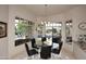 Bright breakfast nook with a pool view, stylish black table, and lots of natural light at 8230 E Via Del Sol Dr, Scottsdale, AZ 85255