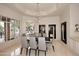 Bright dining space features stylish furnishings and an elegant chandelier, bathed in natural light at 8230 E Via Del Sol Dr, Scottsdale, AZ 85255
