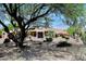 Beautiful desert home with manicured landscaping, a gated courtyard, and mature trees at 8230 E Via Del Sol Dr, Scottsdale, AZ 85255