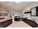 Spacious kitchen featuring custom cabinets, granite countertops, stainless steel appliances, and a breakfast bar at 8230 E Via Del Sol Dr, Scottsdale, AZ 85255
