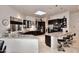 Bright kitchen features an eat-in granite counter, stainless appliances, and dark wood cabinetry at 8230 E Via Del Sol Dr, Scottsdale, AZ 85255