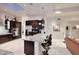 Modern kitchen with an island, sleek dark cabinetry, stainless appliances, and tile backsplash at 8230 E Via Del Sol Dr, Scottsdale, AZ 85255