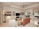Bright living room with tile floors, fireplace, built-in shelving, and sliding doors to the patio at 8230 E Via Del Sol Dr, Scottsdale, AZ 85255