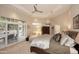 Relaxing main bedroom with access to outdoor seating area, a ceiling fan, and neutral colors at 8230 E Via Del Sol Dr, Scottsdale, AZ 85255