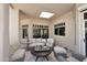 Covered patio featuring comfortable seating and views of the backyard at 8230 E Via Del Sol Dr, Scottsdale, AZ 85255