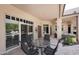 Covered patio with outdoor seating and views of the landscaped backyard at 8230 E Via Del Sol Dr, Scottsdale, AZ 85255