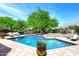 Refreshing backyard pool with a beautiful stone surround and ample lounge seating at 8230 E Via Del Sol Dr, Scottsdale, AZ 85255