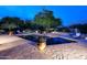 A beautiful pool and landscaped backyard at twilight at 8230 E Via Del Sol Dr, Scottsdale, AZ 85255