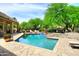 Beautiful backyard pool with mature landscaping and a stone deck at 8230 E Via Del Sol Dr, Scottsdale, AZ 85255