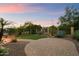 Professionally landscaped backyard featuring a manicured lawn, mature trees, and decorative stone at 8234 E Inca St, Mesa, AZ 85207
