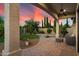 Covered patio with a ceiling fan and landscaped backyard featuring turf and desert plants at 8234 E Inca St, Mesa, AZ 85207