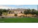 Well maintained backyard with turf, desert landscaping, and rod iron fence at 8234 E Inca St, Mesa, AZ 85207