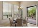 Breakfast nook with round wood table, seating for four, three sunny windows, and access to the backyard at 8234 E Inca St, Mesa, AZ 85207