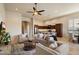 Open concept living room with large seating area, ceiling fan, and view into the modern kitchen at 8234 E Inca St, Mesa, AZ 85207