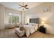Comfortable bedroom with neutral carpet, ceiling fan, plantation shutters, and plenty of natural light at 8234 E Inca St, Mesa, AZ 85207