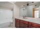 Clean bathroom with a shower-tub combo, cherry vanity, and ample countertop space at 8787 E Mountain View Rd # 2008, Scottsdale, AZ 85258