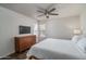 Comfortable bedroom with a neutral color palette, dresser, and ceiling fan at 8787 E Mountain View Rd # 2008, Scottsdale, AZ 85258