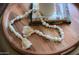 Stylish coffee table decor details with books and decorative beads at 8787 E Mountain View Rd # 2008, Scottsdale, AZ 85258
