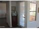 Hallway featuring a door with blinds leading to the outside and a built-in cabinet area at 8787 E Mountain View Rd # 2008, Scottsdale, AZ 85258