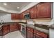Stylish kitchen featuring granite countertops, stainless steel appliances, and cherry cabinetry at 8787 E Mountain View Rd # 2008, Scottsdale, AZ 85258
