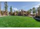 Exterior of apartment buildings overlooking a well-manicured lawn with mature trees at 8787 E Mountain View Rd # 2008, Scottsdale, AZ 85258